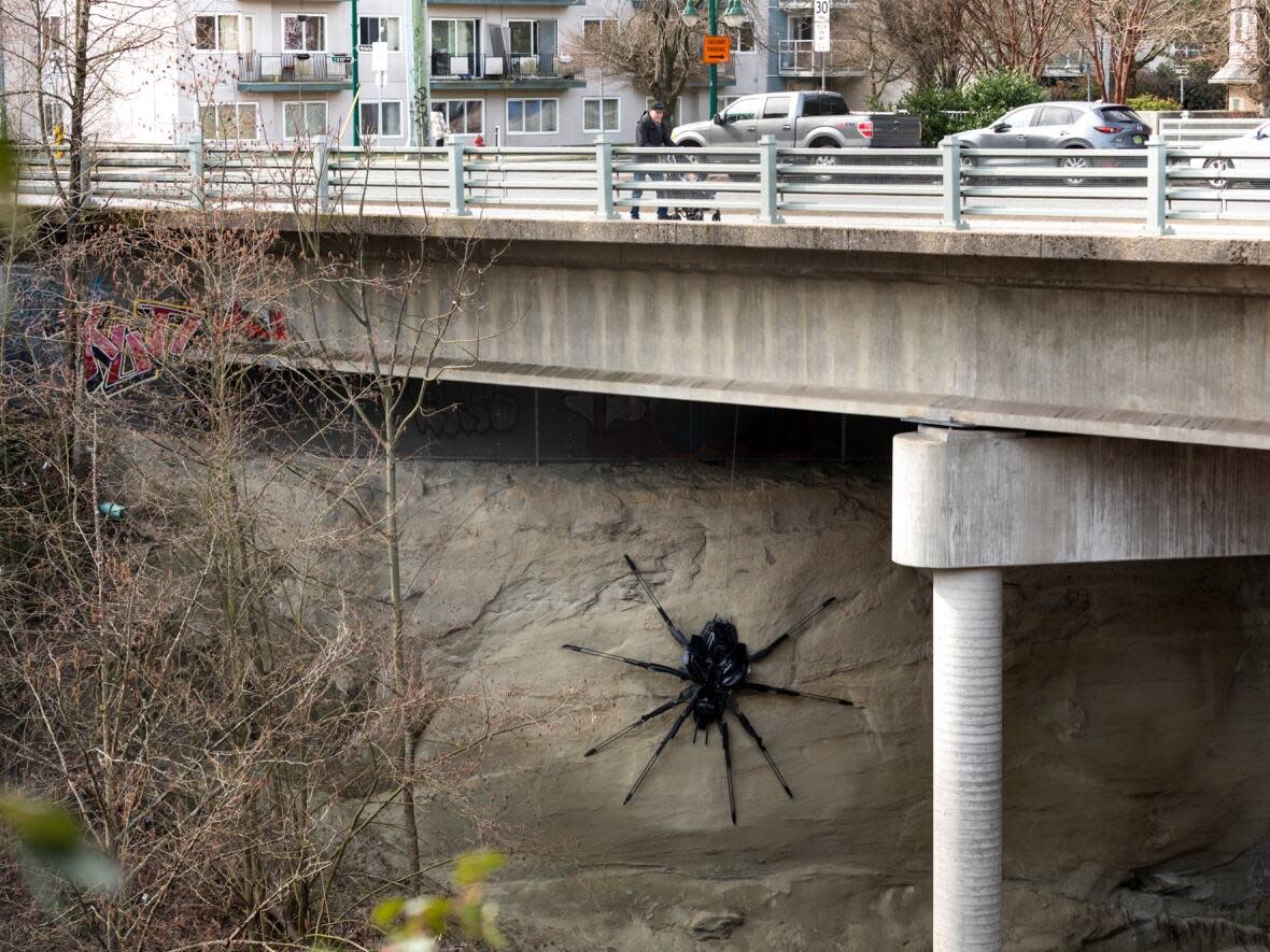 The spider sculpture under the Victoria Drive overpass was created by artist Junko Playtime. (Justine Boulin/CBC - image credit)