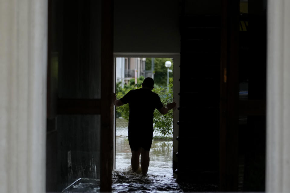 A man walks in a flooded street in the village of Castel Bolognese, Italy, Wednesday, May 17, 2023. Exceptional rains Wednesday in a drought-struck region of northern Italy swelled rivers over their banks, killing at least eight people, forcing the evacuation of thousands and prompting officials to warn that Italy needs a national plan to combat climate change-induced flooding. (AP Photo/Luca Bruno)