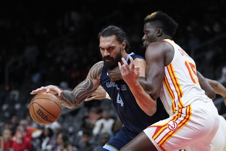 Memphis Grizzlies center Steven Adams (4) works against Atlanta Hawks center Clint Capela (15) during the first half of a preseason NBA basketball Thursday, Oct. 12, 2023, in Atlanta. (AP Photo/John Bazemore)