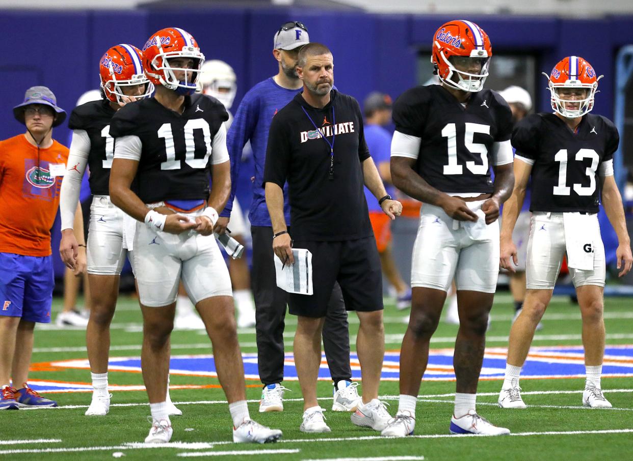 Florida Gators head football coach Billy Napier stands with the quarterbacks during practice at the indoor practice facility on the University of Florida campus in Gainesville FL. August 8, 2022.