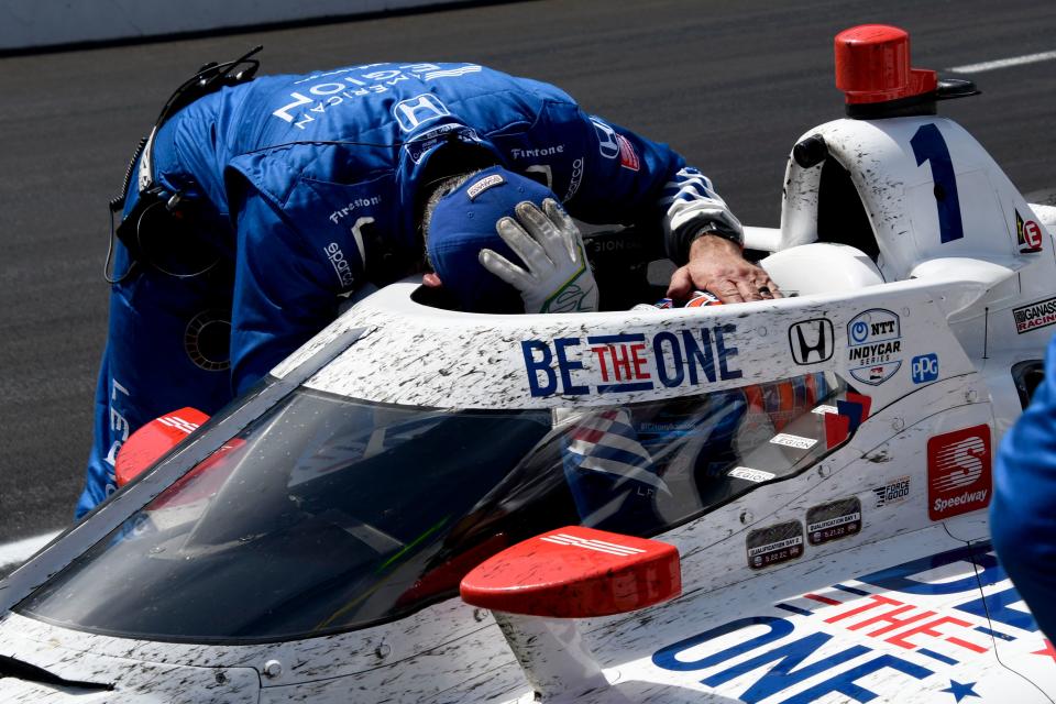 Chip Ganassi Racing driver Tony Kanaan (1) is met by a member of his crew after finishing third Sunday, May 29, 2022, during the 106th running of the Indianapolis 500 at Indianapolis Motor Speedway