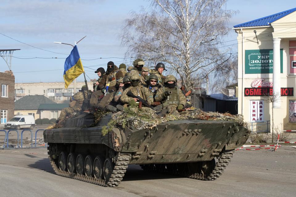 Ukrainian soldiers ride a tank through the town of Trostsyanets, some 400 km eastern of capital Kyiv, Ukraine, Monday, March 28, 2022. The more than month-old war has killed thousands and driven more than 10 million Ukrainians from their homes — including almost 4 million from their country. (AP Photo/Efrem Lukatsky)