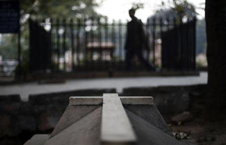 A man walks around the graves at Nicholson Christian Cemetery in old quarters of Delhi February 13, 2014. REUTERS/Adnan Abidi