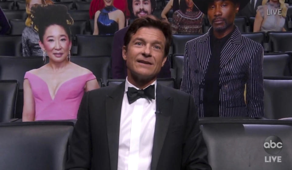 In this video grab captured on Sept. 20, 2020, courtesy of the Academy of Television Arts & Sciences and ABC Entertainment, Jason Bateman appears in the audience surrounded by cardboard cutouts during the 72nd Emmy Awards broadcast. (The Television Academy and ABC Entertainment via AP)