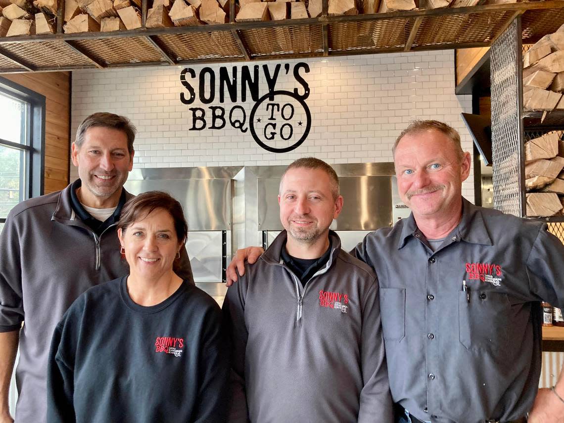 From left, Sonny’s BBQ owner Brad Fink and his wife, Gina, Duane Hartenhoff, general manager, and Steve Jackowiak, area director. Becky Purser/The Telegraph