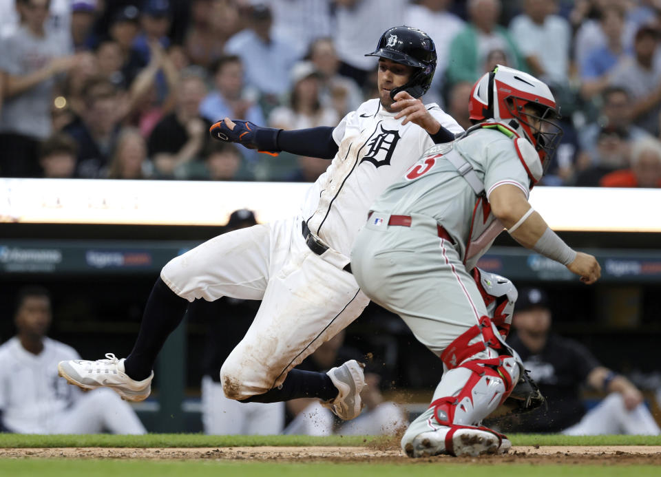 Detroit Tigers' Ryan Kreidler scores past Philadelphia Phillies catcher Rafael Marchan during the fifth inning of a baseball game Tuesday, June 25, 2024, in Detroit. (AP Photo/Duane Burleson)