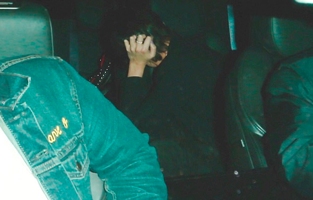 The camera-shy couple hide their faces while exiting the Hollywood venue. Source: Backgrid