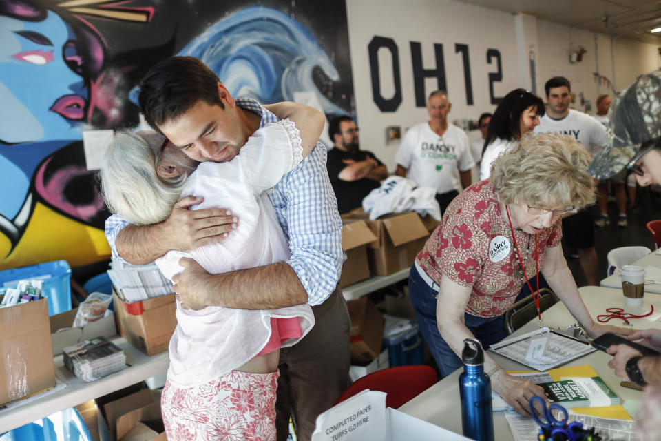 Democrat Danny O'Connor, the Franklin County recorder, hugs a supper at his campaign headquarters, Tuesday, Aug. 7, 2018, in Columbus. The script for Ohio's special election is perhaps familiar: An experienced Trump loyalist, two-term state Sen. Troy Balderson, is fighting off a strong challenge from a fresh-faced Democrat, 31-year-old county official Danny O'Connor, in a congressional district held by the Republican Party for more than three decades. (AP Photo/John Minchillo)