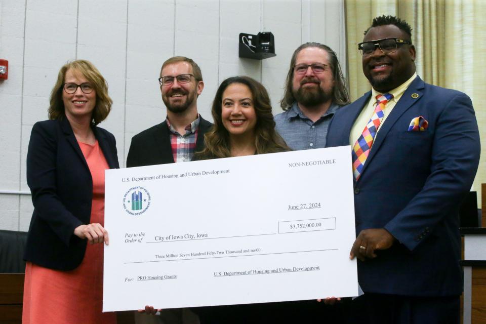 From left, Tracy Hightshoe, Kirk Lehmann, Elizabeth de León Bhargava, Shawn Harmsen and Bruce Teague pose for a photo as the city received a $3.75 million housing grant from the U.S. Department of Housing and Urban Development on Thursday, June 27, 2024 in Iowa City, Iowa.