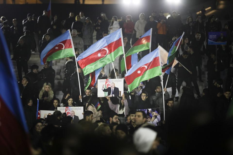 People wave national flags celebrating Azerbaijan's President Ilhan Aliyev's victory in the presidential election in Baku, Azerbaijan, Wednesday, Feb. 7, 2024. Azerbaijanis voted Wednesday in an election almost certain to see incumbent President Ilhan Aliyev chosen to serve another seven-year term. (AP Photo)