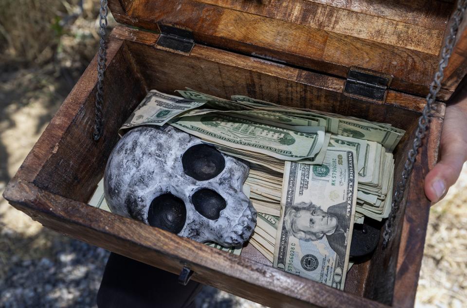 The contents of a small trunk that Chelsea Gotta of Pella, Iowa, found off Mueller Park Trail in the mountains east of Bountiful on Sunday, July 16, 2023. Gotta has been in Utah multiple times over the past weeks to search for the hidden treasure. | Scott G Winterton, Deseret News