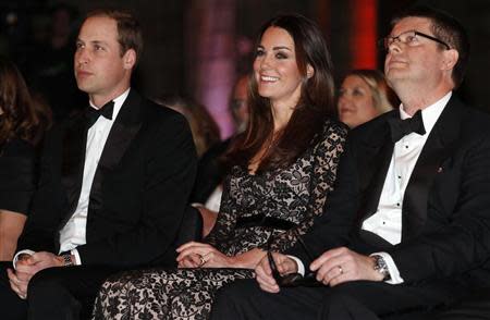 Britain's Prince William (L-R) and his wife Catherine, the Duchess of Cambridge, sit with Natural History Museum Director Michael Dixon before a screening of "David Attenborough's Natural History Museum Alive 3D" at the museum in London December 11, 2013. REUTERS/Suzanne Plunkett