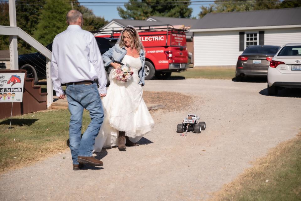 Samantha and Jesse Snellen were married on their property in Bullitt County on Oct. 9, 2022. The couple rigged an RC car to serve as sing bearer.