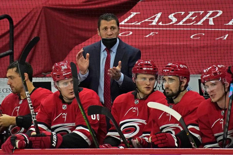 Carolina Hurricanes coach Rod Brind’Amour, top, encourages his team during the second period of an NHL hockey game against the Columbus Blue Jackets in Raleigh, N.C., Saturday, March 20, 2021. (AP Photo/Gerry Broome)