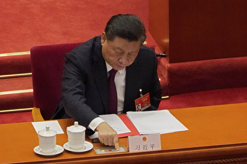 President Xi Jinping casts his vote during the closing session of the National People's Congress (NPC) at the Great Hall of the People in Beijing, Thursday, March 11, 2021. China's ceremonial legislature on Thursday endorsed the ruling Communist Party's latest move to tighten control over Hong Kong by reducing the role of its public in picking the territory's leaders. (AP Photo/Sam McNeil)