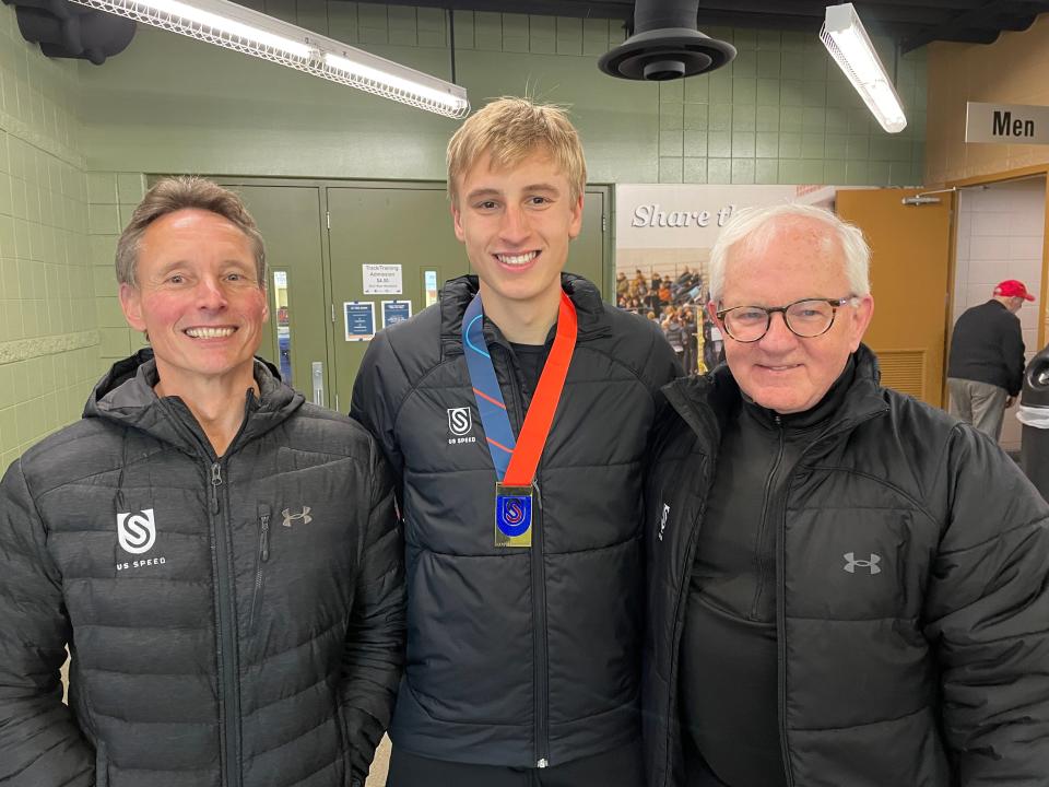 Jordan Stolz, center, poses for a photo with his father Dirk, left, and coach Bob Corby at the US Long Track speed skating championships Friday at the Pettit National Ice Center in Milwaukee.