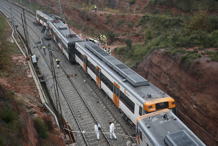 Rescue workers survey the scene after a commuter train derailed between Terrassa and Manresa, outside Barcelona, Spain, November 20, 2018. REUTERS/Albert Gea