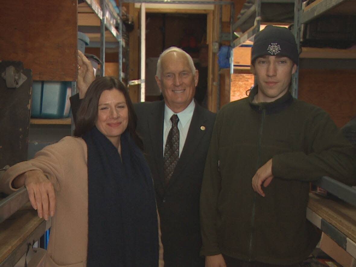 From left, Laura MacKenzie, executive director of Screen Nova Scotia; Communities, Culture, Tourism and Heritage Minister Pat Dunn; and Sullivan's Crossing set dresser William Greig. They posed for a photo after the tax incentive announcement in Halifax. (CBC - image credit)