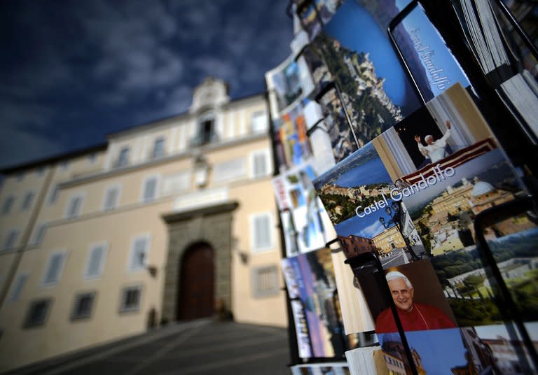 Postcards are displayed on February 20, 2013 outside a souvenir shop by the Apostolic Palace on the main square of Castel Gandolfo, Italy. Some cardinals have cautioned that since there are no clear favourites for the succession this time around, the conclave could take longer than the two days it took them to elect Pope Benedict