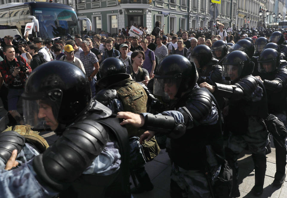 FILE - in this file photo dated Saturday, July 27, 2019, police block a street during an unsanctioned rally in the center of Moscow, Russia. Moscow’s children’s rights ombudsman and other public figures Wednesday Aug. 7, 2019, have reacted with outrage to Russian prosecutors’ moves to strip a couple of custody of their 1-year old son for allegedly taking him to this unauthorized protest on July 27. (AP Photo/ Pavel Golovkin, FILE)