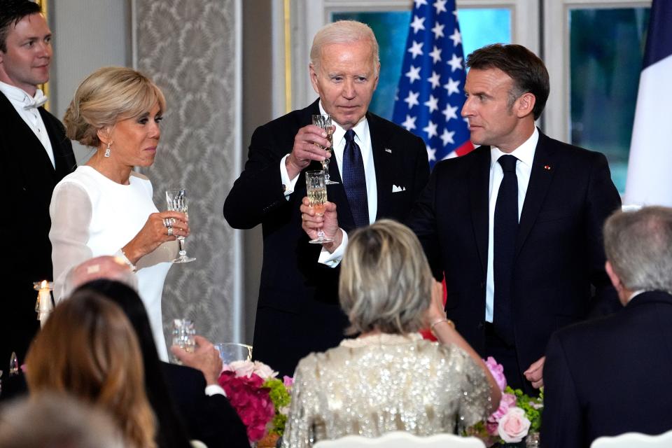 French President Emmanuel Macron, from right, President Joe Biden and Brigitte Macron toast during a state dinner (AP)