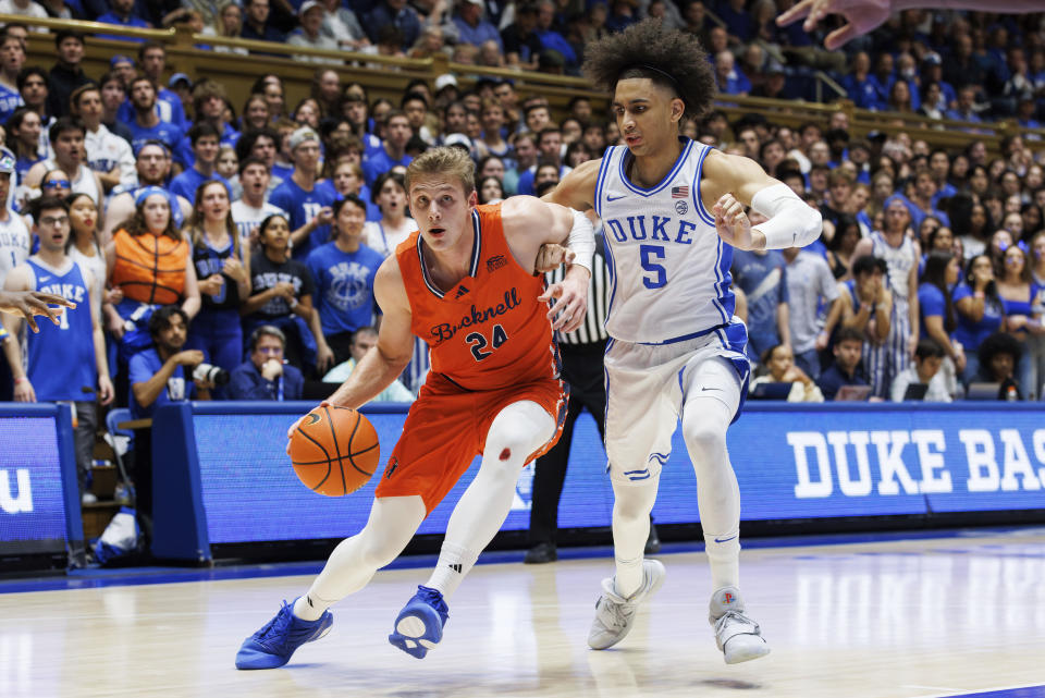 Bucknell's Jack Forrest (24) drives as Duke's Tyrese Proctor (5) defends during the first half of an NCAA college basketball game in Durham, N.C., Friday, Nov. 17, 2023. (AP Photo/Ben McKeown)