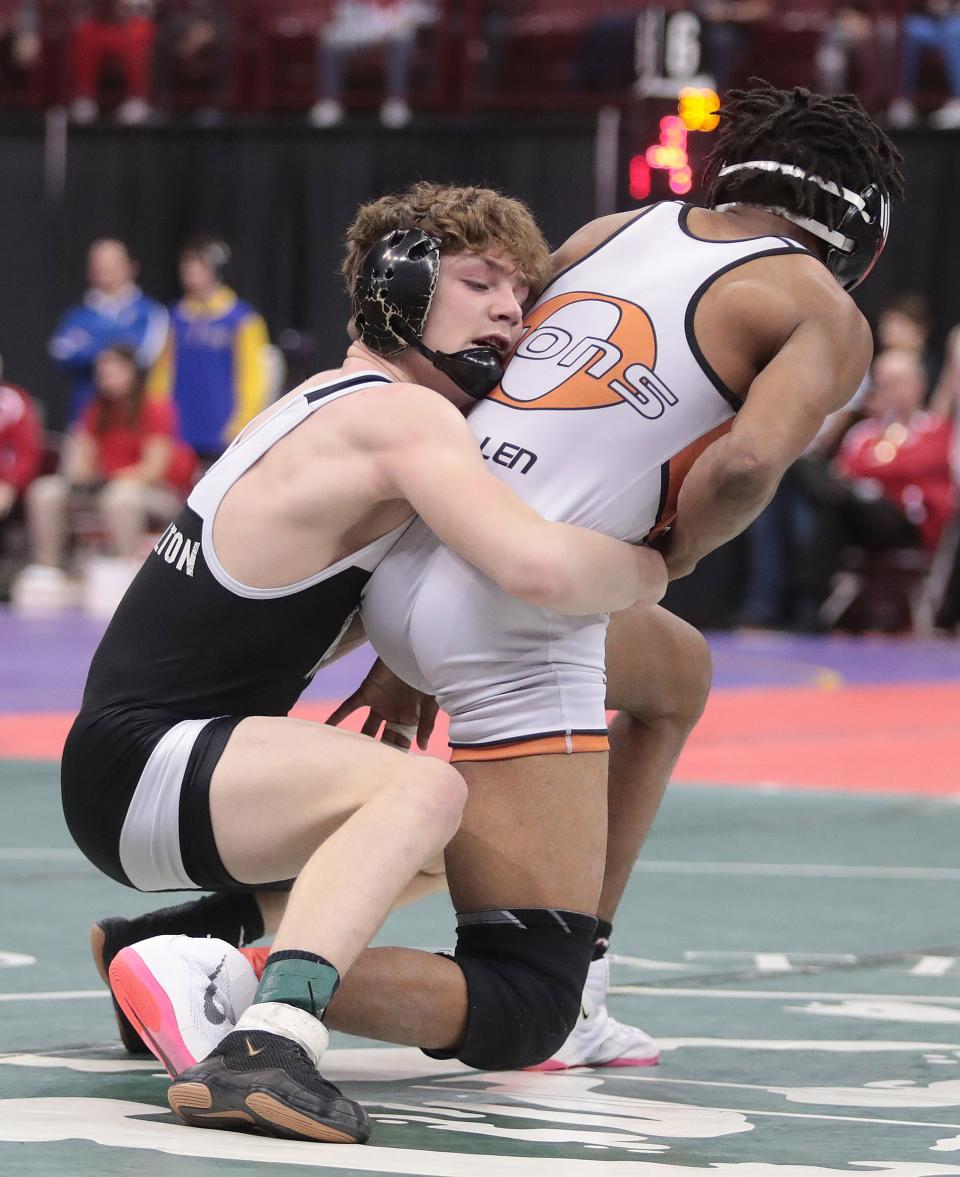 Carrollton's Josh Carman left, wrestles Orange's Te'Andre Allen in the 126 pound weight class during Sundays consolation semifinals at the OHSAA State Wrestling tournament.