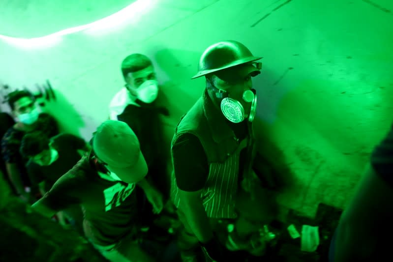 Iraqi demonstrators are seen inside the high-rise building, called by Iraqi the Turkish Restaurant Building, during anti-government protests in Baghdad