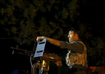 An Afghan policeman keeps watch near the site of an attack in Kabul, Afghanistan early May 27, 2015. REUTERS/Mohammad Ismail