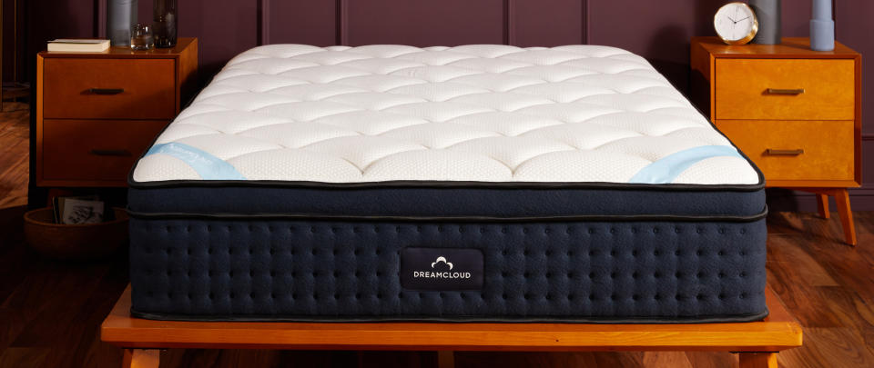  The DreamCloud Premier Hybrid Mattress on a wooden bedframe. 