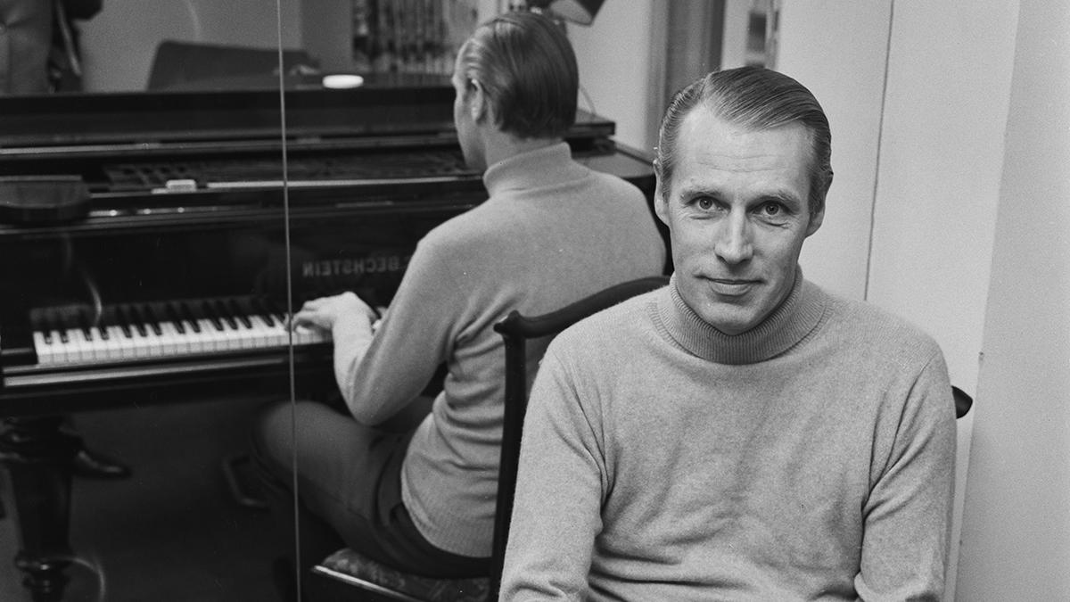  George Martin sitting at the piano 