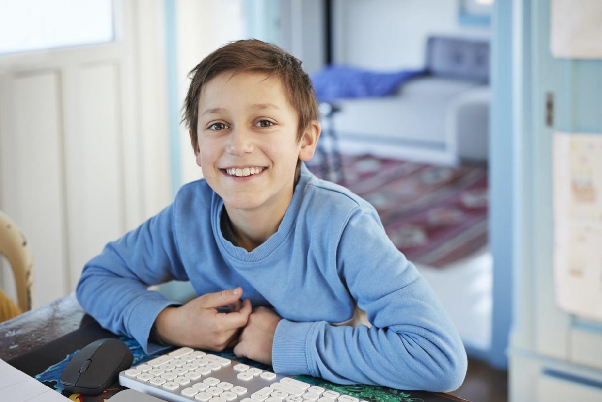 <span class="caption">Children with ADHD typically exhibit a combination of hyperactivity, inattentiveness and/or impulsive behavior. </span> <span class="attribution"><a class="link " href="https://www.gettyimages.com/detail/photo/portrait-smiling-boy-using-computer-at-table-royalty-free-image/1216407249?adppopup=true" rel="nofollow noopener" target="_blank" data-ylk="slk:Klaus Vedfelt/Digital Vision via Getty Images;elm:context_link;itc:0;sec:content-canvas">Klaus Vedfelt/Digital Vision via Getty Images</a></span>