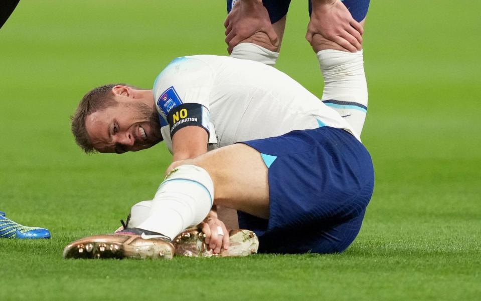 File photo dated 21-11-2022 of England's Harry Kane holds his ankle. England captain Harry Kane is set to have a scan on his right ankle before Fridayâ€™s World Cup match against the United States - Martin Rickett/PA Wire