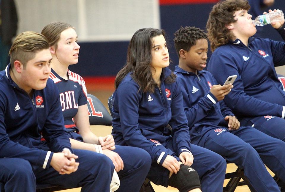 Alessia Agostini (middle) sits with teammates (left to right) Javi Paredes, Katie Sites, Patrell Childs and Junior Arellano prior to competing against Columbus North.
