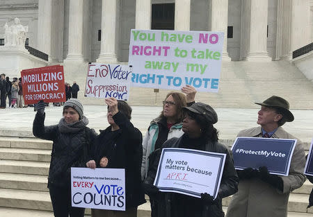 Activists rally outside the U.S. Supreme Court ahead of arguments in a key voting rights case involving a challenge to the OhioÕs policy of purging infrequent voters from voter registration rolls, in Washington, U.S., January 10, 2018. REUTERS/Lawrence Hurley