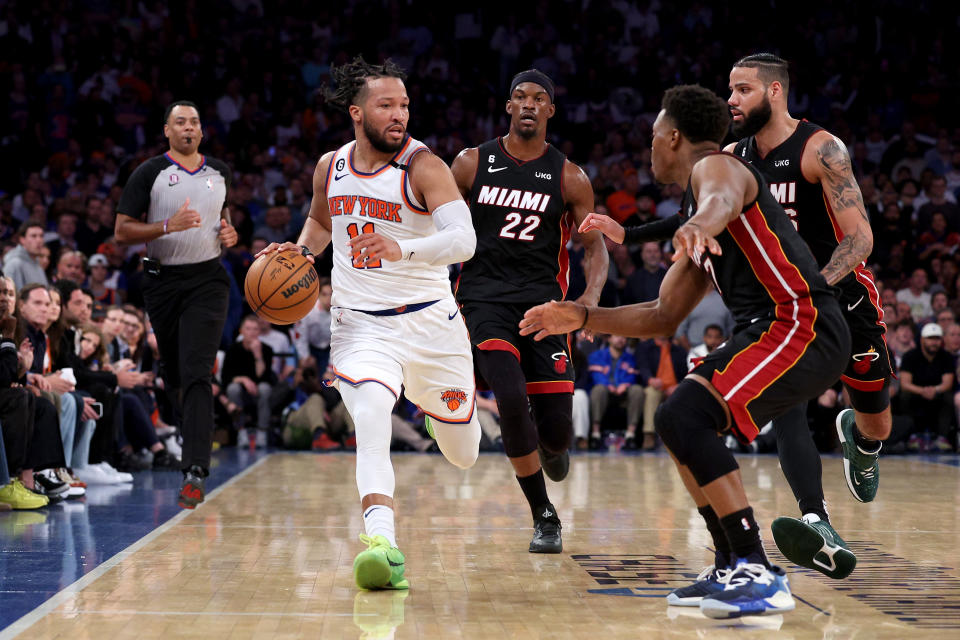 NEW YORK, NEW YORK - MAY 10: Jalen Brunson #11 of the New York Knicks dribbles against Jimmy Butler #22, Caleb Martin #16 and Kyle Lowry #7 of the Miami Heat during the fourth quarter in game five of the Eastern Conference Semifinals in the 2023 NBA Playoffs at Madison Square Garden on May 10, 2023 in New York City. NOTE TO USER: User expressly acknowledges and agrees that, by downloading and or using this photograph, User is consenting to the terms and conditions of the Getty Images License Agreement. (Photo by Elsa/Getty Images)