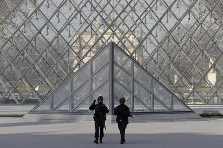 French police secure the site near the Louvre Pyramid in Paris, France, February 3, 2017 after a French soldier shot and wounded a man armed with a knife after he tried to enter the Louvre museum in central Paris carrying a suitcase, police sources said. REUTERS/Christian Hartmann