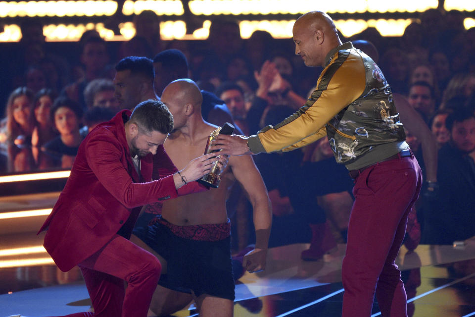 Zachary Levi bows as he presents the generation award to Dwayne Johnson, also known as The Rock, at the MTV Movie and TV Awards on Saturday, June 15, 2019, at the Barker Hangar in Santa Monica, Calif. (Photo by Chris Pizzello/Invision/AP)