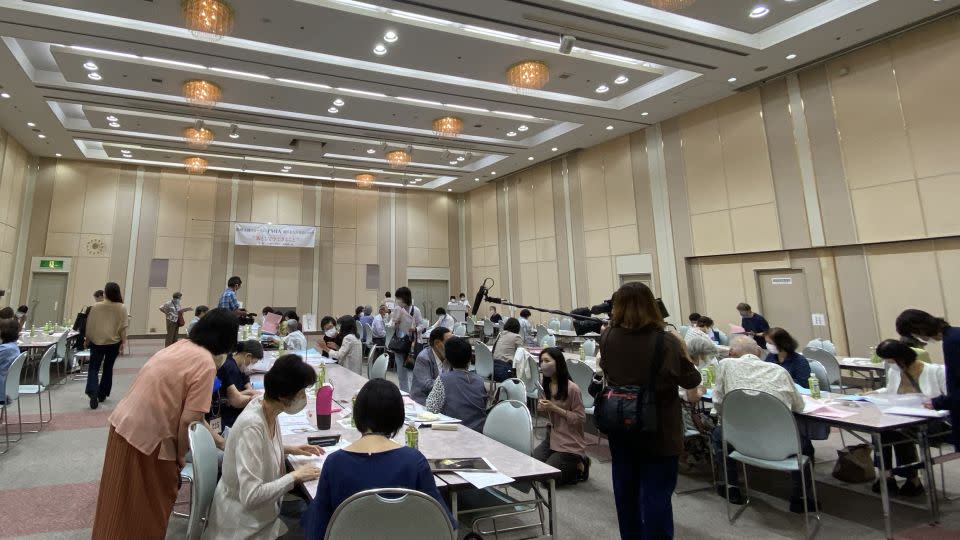 Parents take part in a matchmaking session for their grown-up children organised by the Association of Parents of Marriage Proposal Information in Osaka on July 19. - Junko Fukutome/CNN