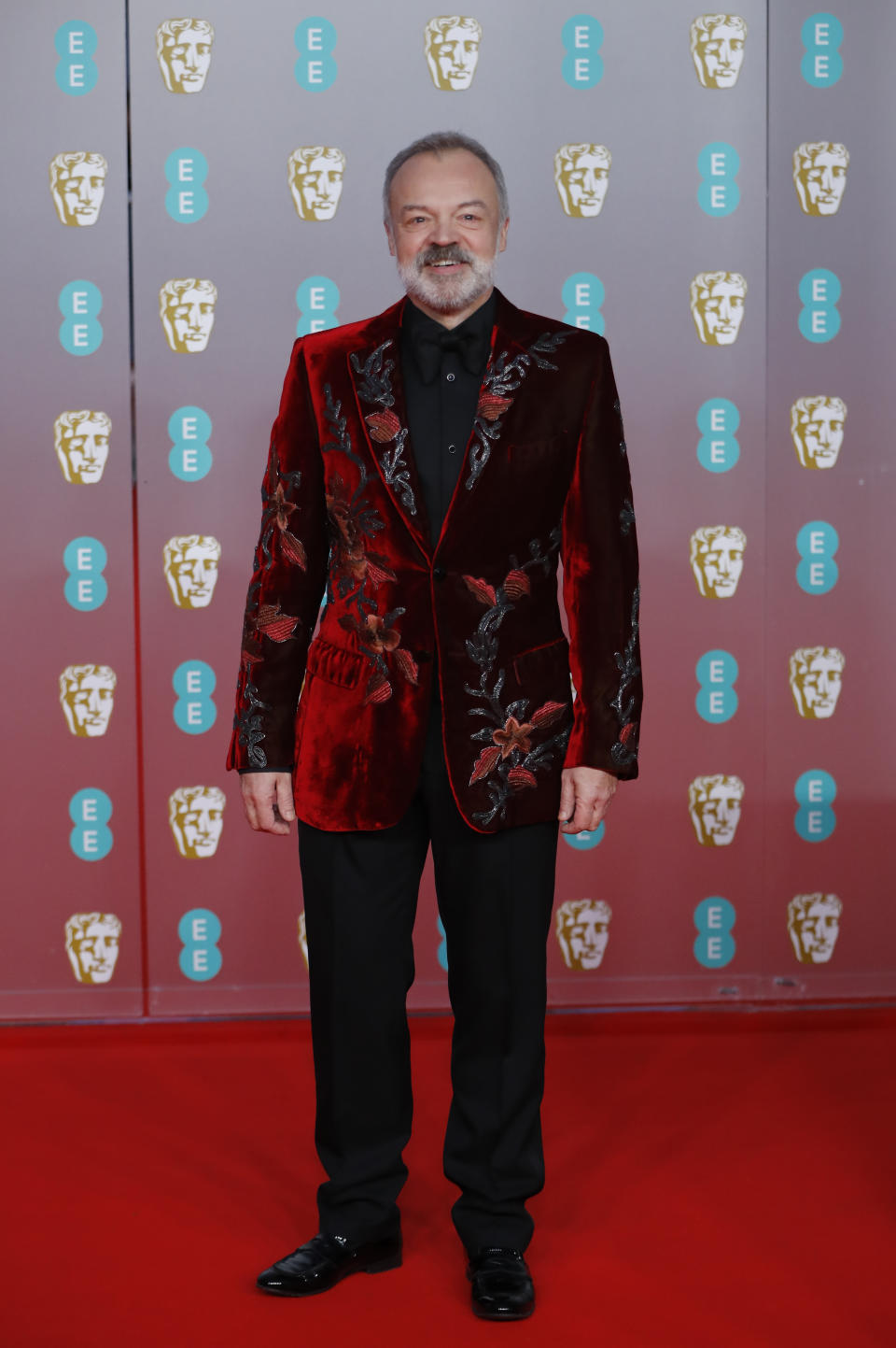 Graham Norton wore a statement red velvet suit jacket for the evening