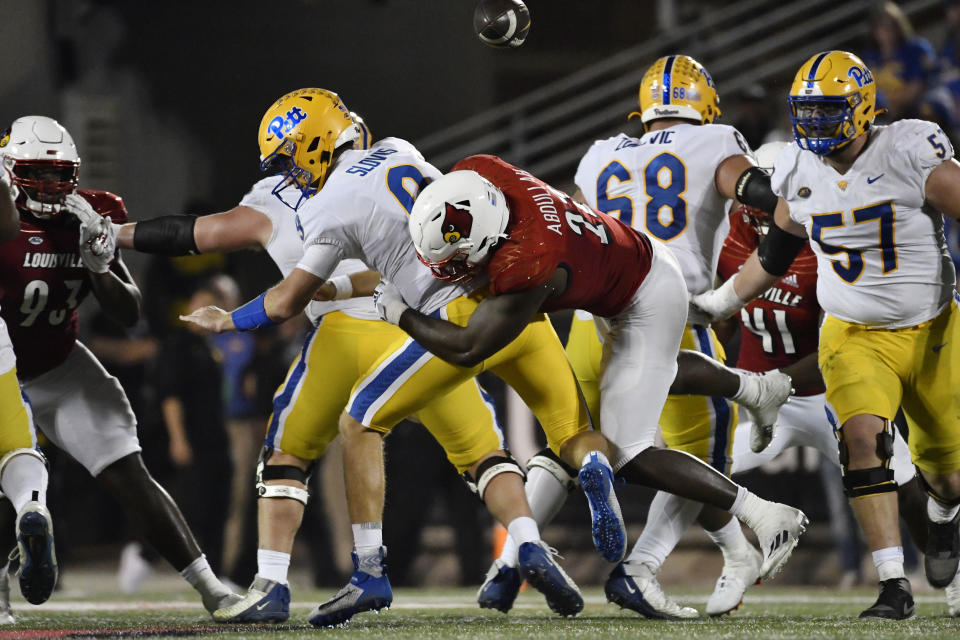 Louisville linebacker Yasir Abdullah (22) hits Pittsburgh quarterback Kedon Slovis (9) in the backfield forcing a fumble during the second half of an NCAA college football game in Louisville, Ky., Saturday, Oct. 22, 2022. (AP Photo/Timothy D. Easley)