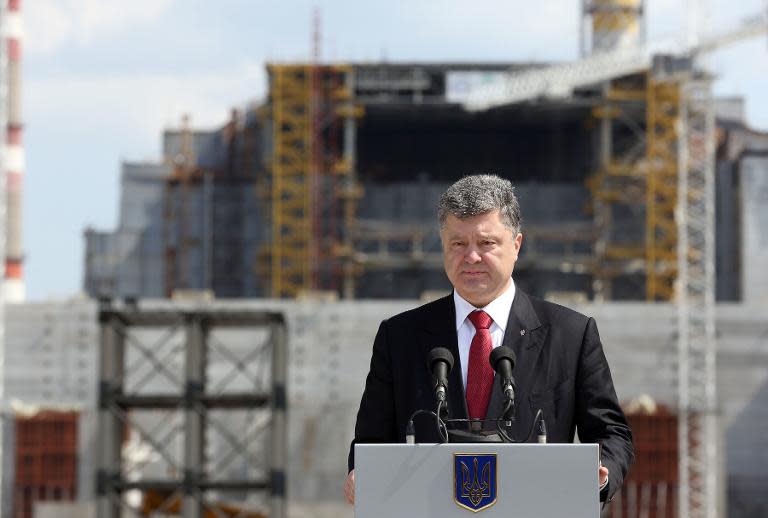 A handout picture taken on April 26, 2015 by the Ukrainian presidential press service shows President Petro Poroshenko delivering a speech at the construction site of the Chernobyl New Safe Confinement structure