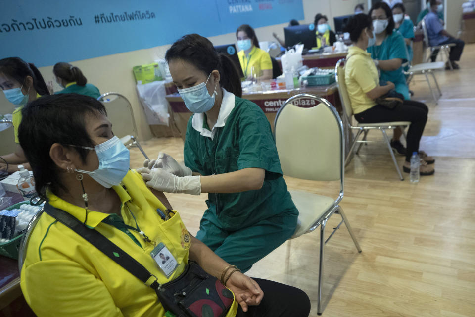 Health workers administer shots of the Sinovac COVID-19 vaccine for Thai citizens at a shopping mall in Bangkok, Thailand, Monday, May 24, 2021. (AP Photo/Sakchai Lalit)