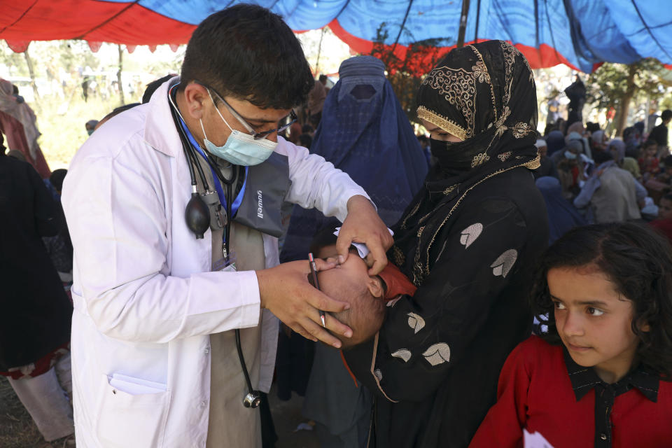 Internally displaced Afghans from northern provinces, who fled their home due to fighting between the Taliban and Afghan security personnel, receive medical care after taking refuge in a public park in Kabul, Afghanistan, Tuesday, Aug. 10, 2021. (AP Photo/Rahmat Gul)