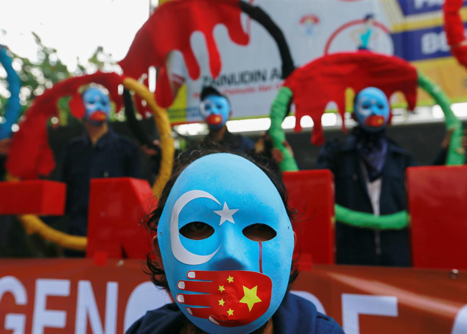 Activists wearing masks take part in a protest to boycott the Beijing 2022 Winter Olympic Games outside the Ministry of Youth and Sport of the Republic of Indonesia building in Jakarta, Indonesia, June 25, 2021. REUTERS/Ajeng Dinar Ulfiana