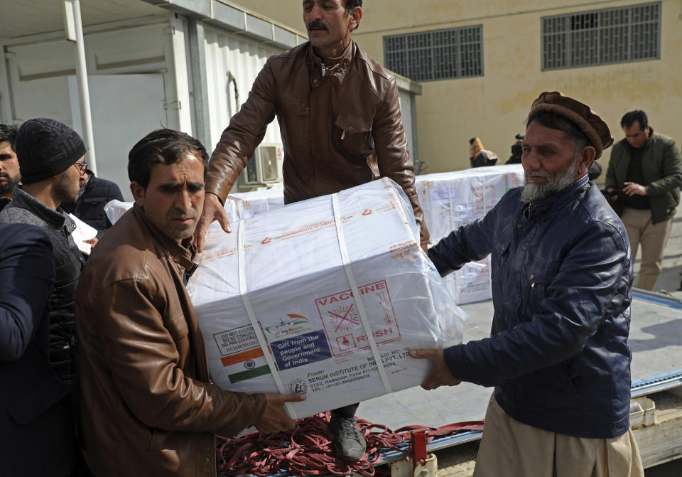 FILE - In this Feb. 7, 2021, file photo, Afghan health ministry workers unload boxes of the first shipment of 500,000 doses of the AstraZeneca coronavirus vaccine made by Serum Institute of India, donated by the Indian government to Afghanistan, at the customs area of the Hamid Karzai International Airport, in Kabul, Afghanistan. As the coronavirus pandemic exploded worldwide last April, global organizations banded together to help ensure vaccines would be distributed fairly. But the COVAX initiative has been dogged by shortages of cash and supplies as well as logistical hurdles. Some poorer countries have been unwilling to wait for COVAX, and have found other ways to get vaccines. (AP Photo/Rahmat Gul, File)