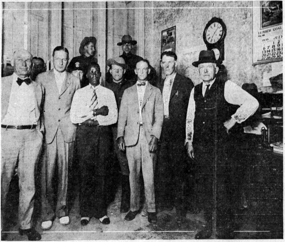 Herbert Johnson, in striped tie, was photographed July 17, 1930, with Schoharie County, N.Y., lawmen at the office in which he'd struggled with Sheriff Henry Steadman over a gun, fatally wounding the sheriff. Second from right is Deputy Sheriff Morgan Lynk and second from left is District Attorney Sharon J. Mauhs, who would prosecute Johnson for murder.