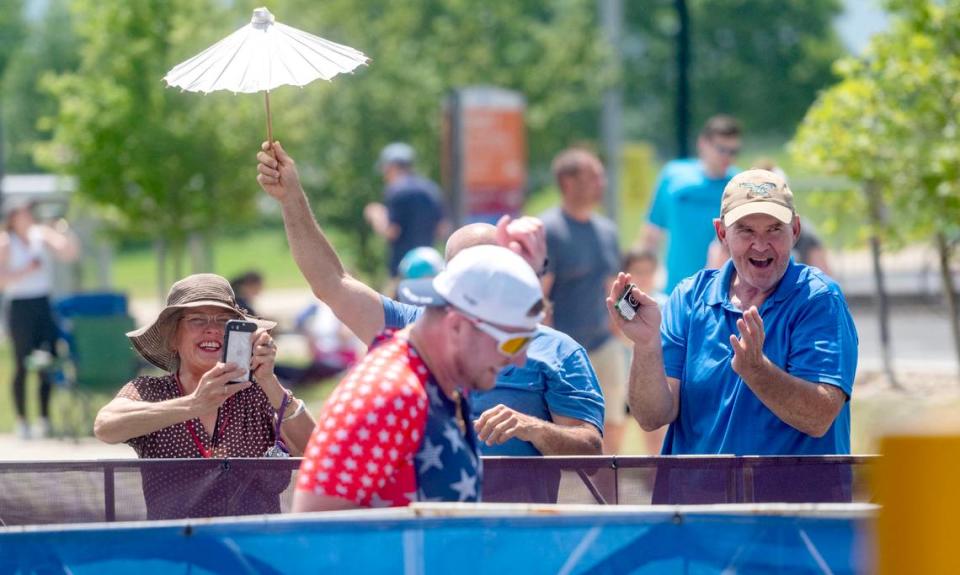 An athlete laughs as he is cheered on during the Ironman 70.3 Pennsylvania Happy Valley on Sunday, June 30, 2024.