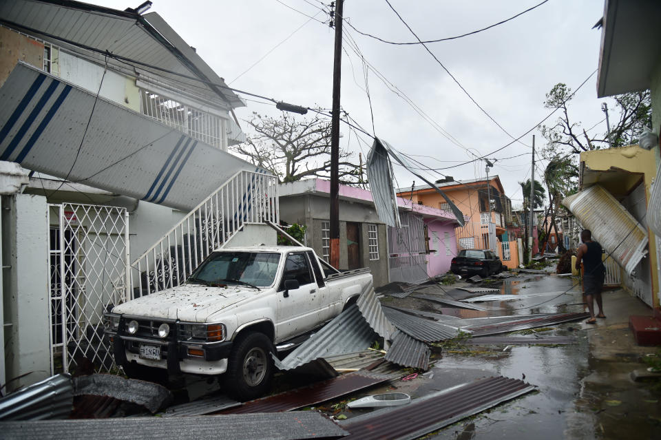 Residents of San Juan, Puerto Rico, deal with damage to their homes on Sept. 20, 2017, as Hurricane Maria batters the island.