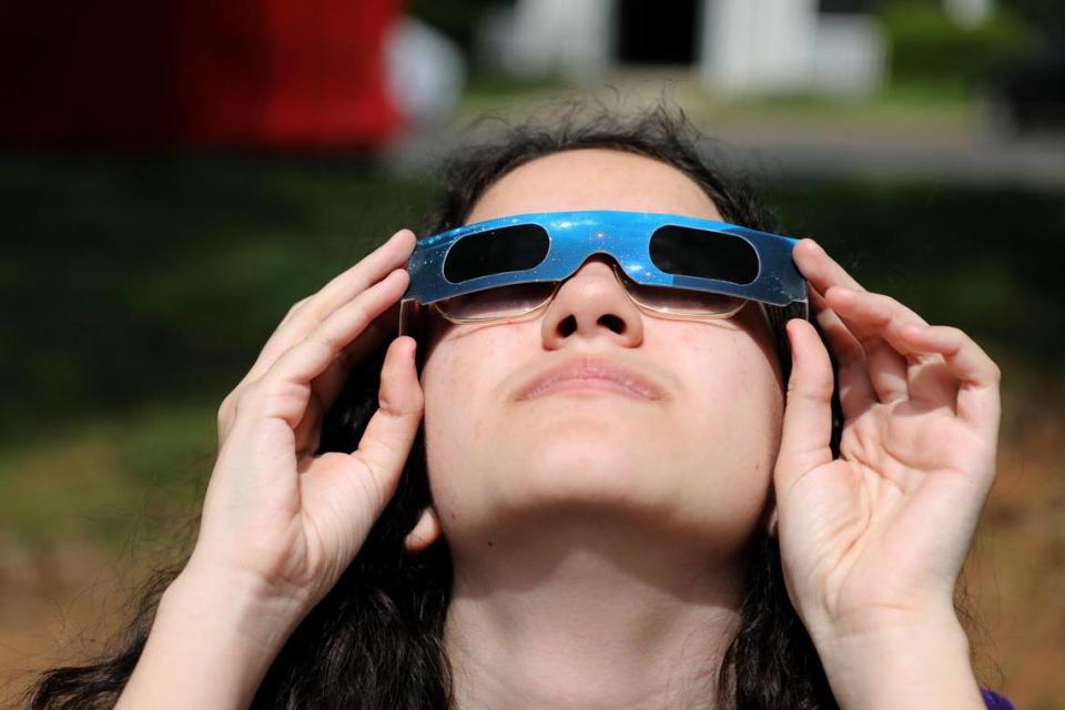 Ashlyn Kelly, 13, checks out the solar eclipse Monday, in Mint Hill, NC. “I learn not to look at the sun in science class,” says Ashlyn.